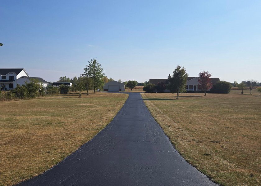 finished driveway surface after sealcoating and detail work