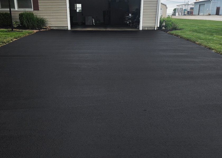 sealed driveway approach with a clean blacktop finish
