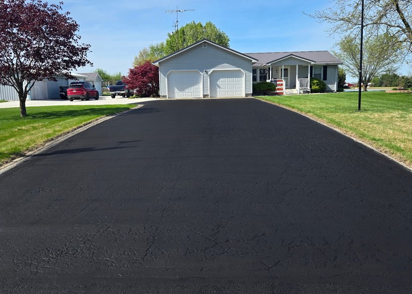 driveway turnaround with fresh asphalt sealer