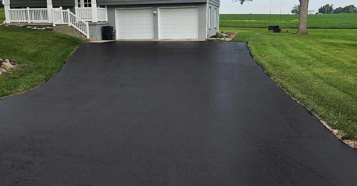 freshly repaired asphalt driveway after work