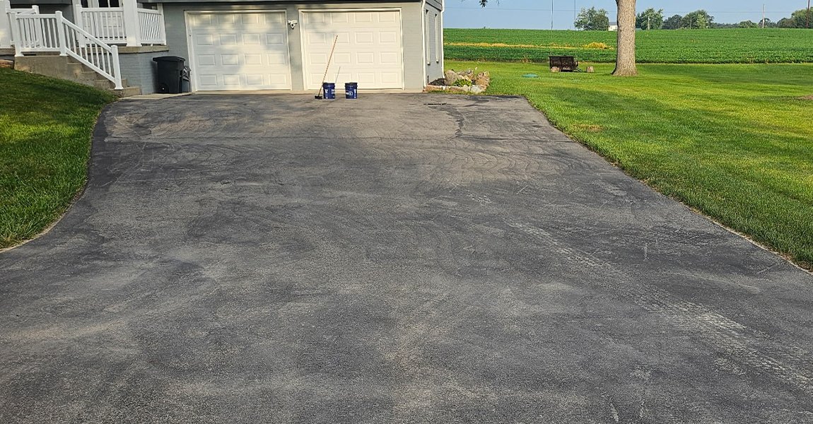 worn asphalt driveway before repair work