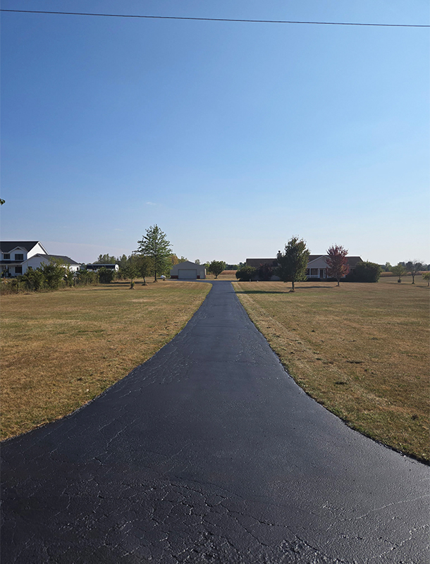 finished driveway surface after sealcoating and detail work