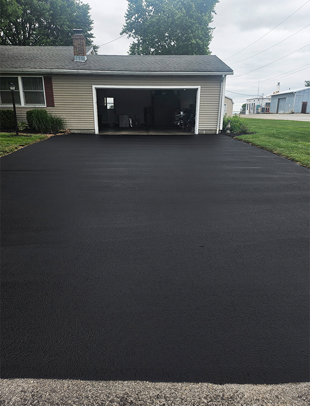 sealed driveway approach with a clean blacktop finish